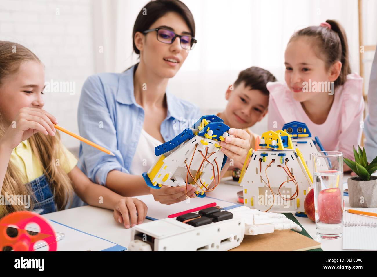 Engaging Robotics Workshop for Children With a Skilled Instructor in a Bright Learning Space Stock Photo