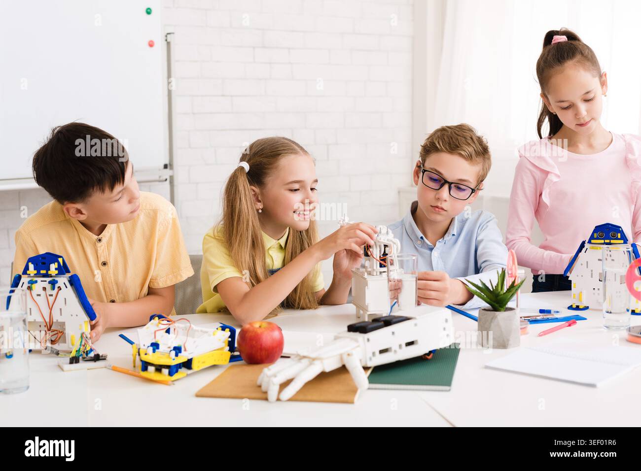 Kids Engaged in Creative Robotics Activity in Bright Classroom Setting Stock Photo