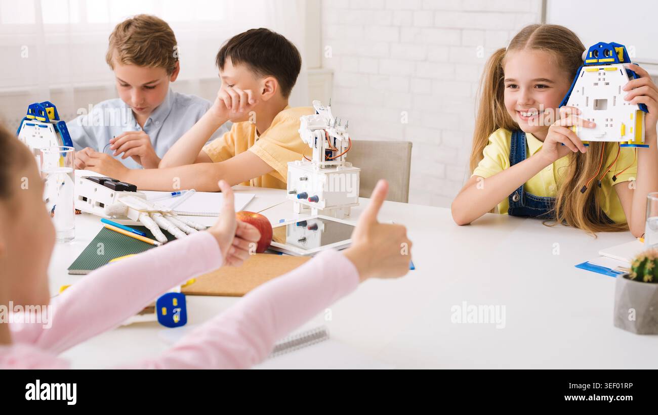 Children Engaged in a Fun Robotics Activity in a Bright Classroom Setting Stock Photo