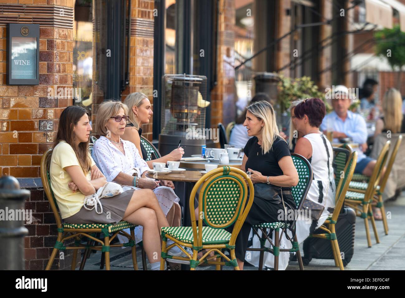 People dining outdoors at restaurants in Mayfair, London during summer. Stock Photo