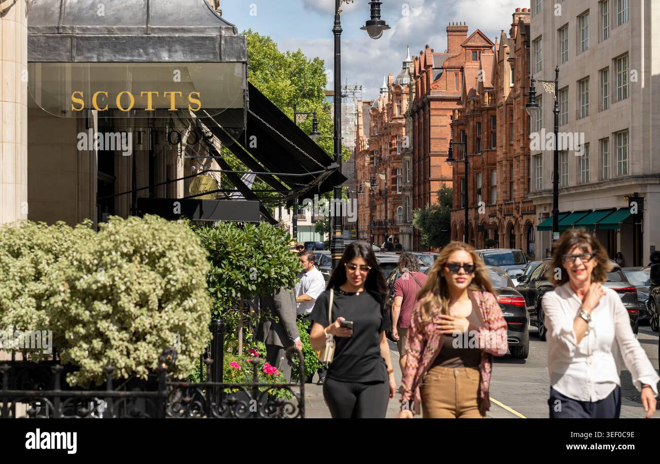 Fashionable pedestrians outside Scott's restaurant in Mayfair, London. Stock Photo