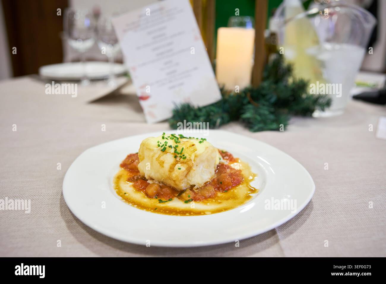 Cod cooked in sauce, served as a second course at a wedding. Andalusia, Spain Stock Photo