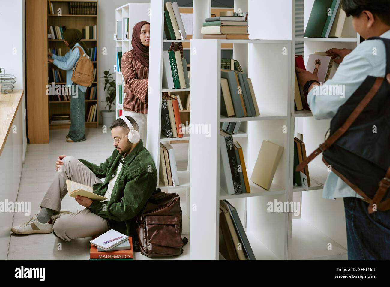 Diverse College Students Studying in Library for Migrant Education Stock Photo