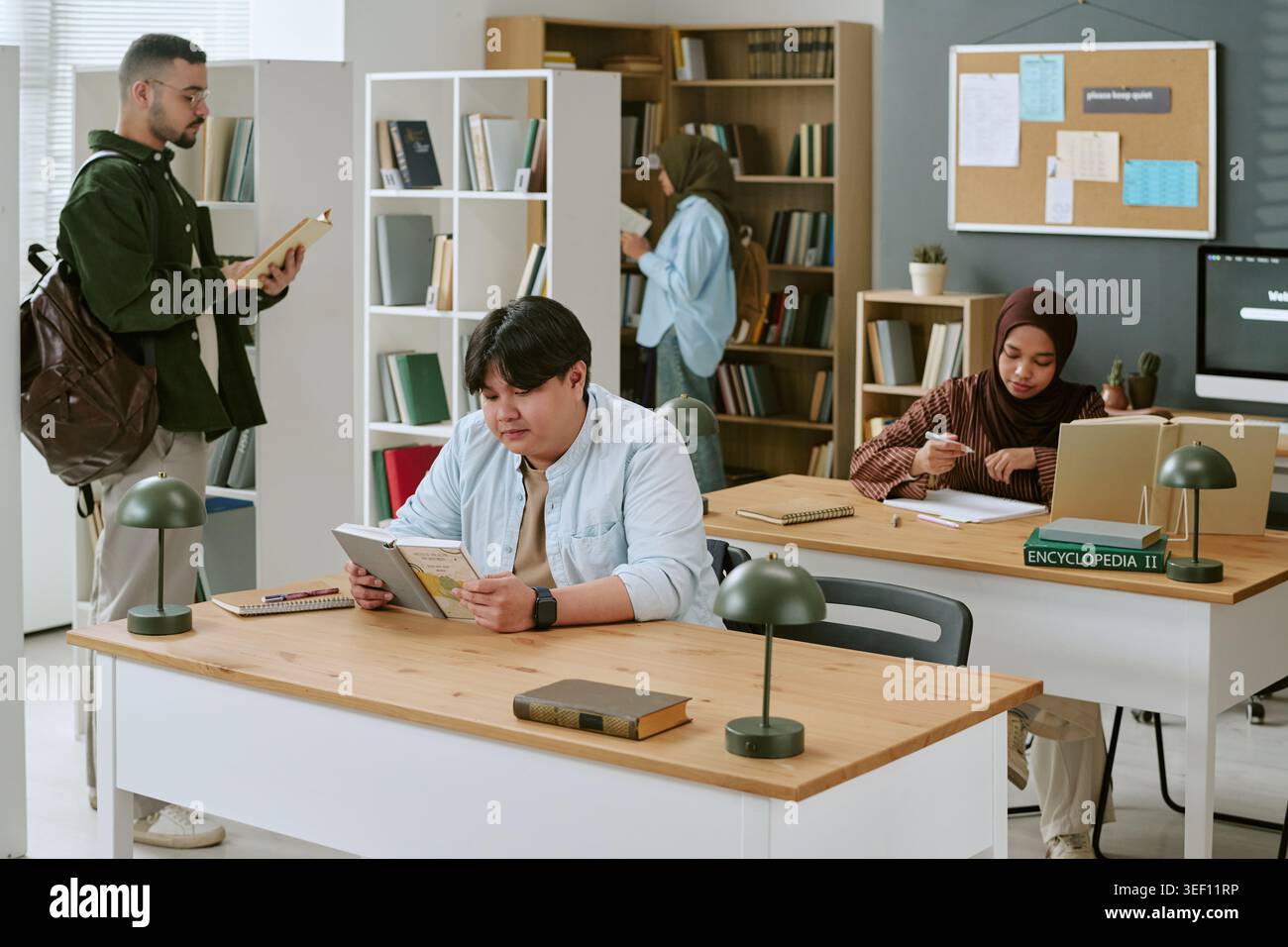 Multiethnic Students Studying in Library for Migrant Education Stock Photo