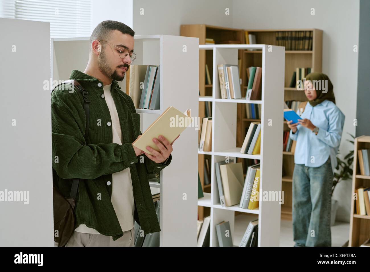 Migrant Man Studying in Library for Education Integration Campaign Stock Photo