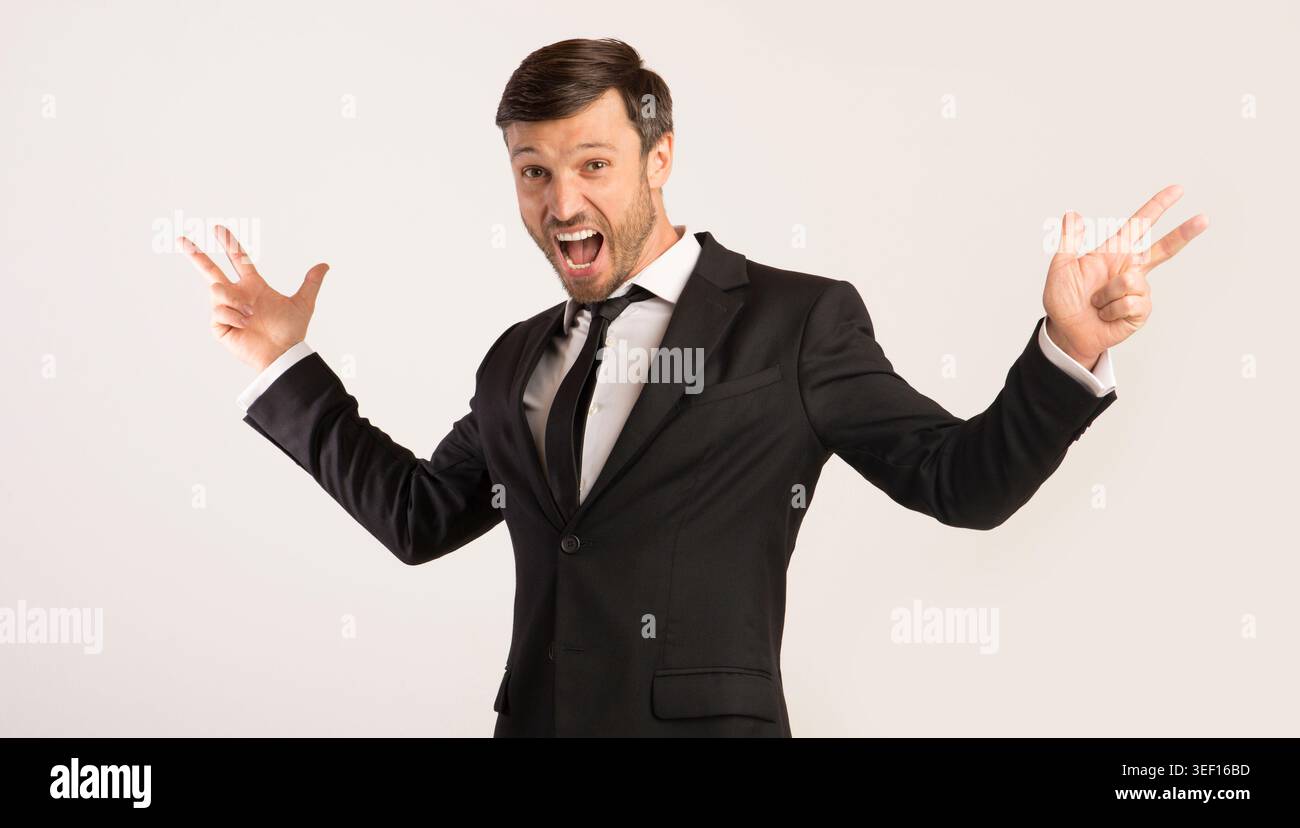 Excited Man Shouting Spreading Hands Standing On White Background Stock Photo