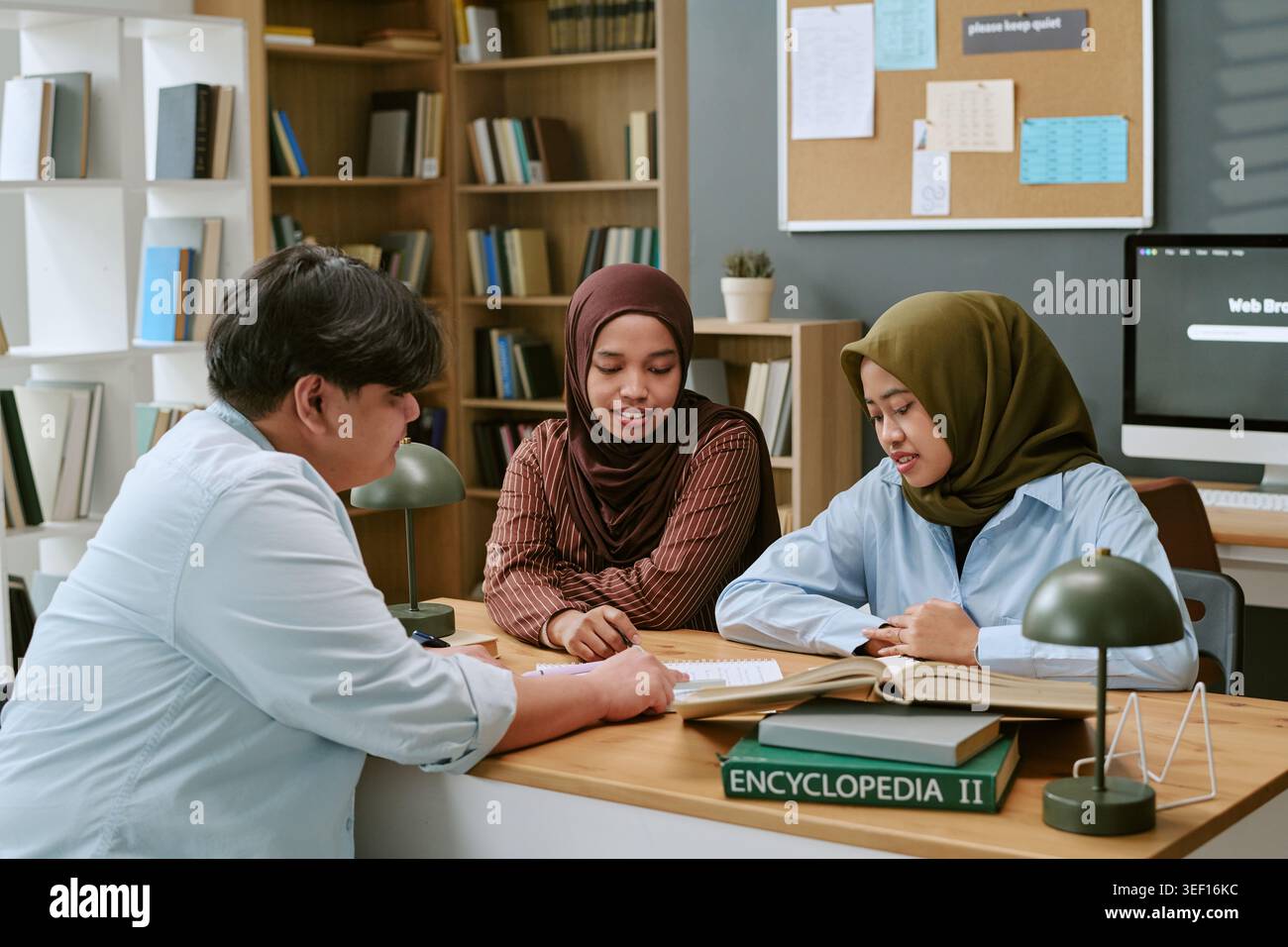 Asian Students Studying Together in Library for Education Support Stock Photo