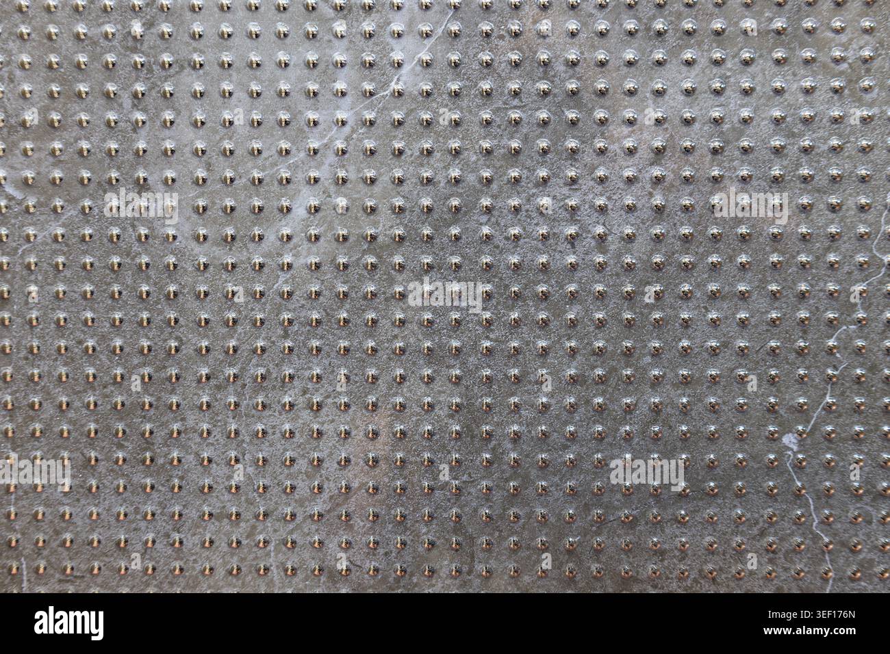Gray industrial tile texture with repeating geometric grid pattern Stock Photo
