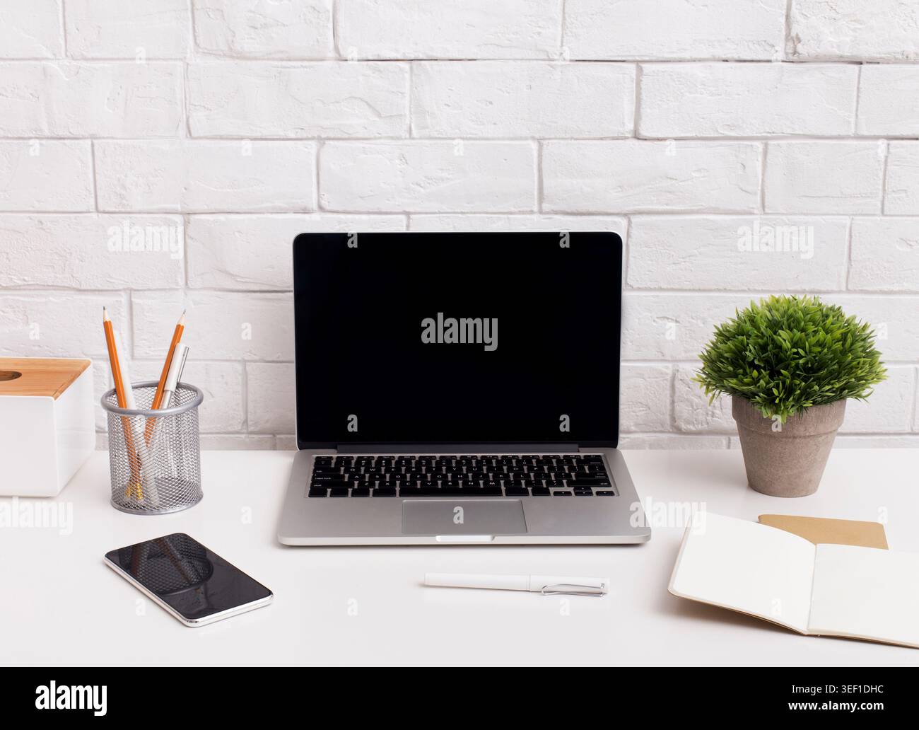 Laptop with black screen on office table Stock Photo