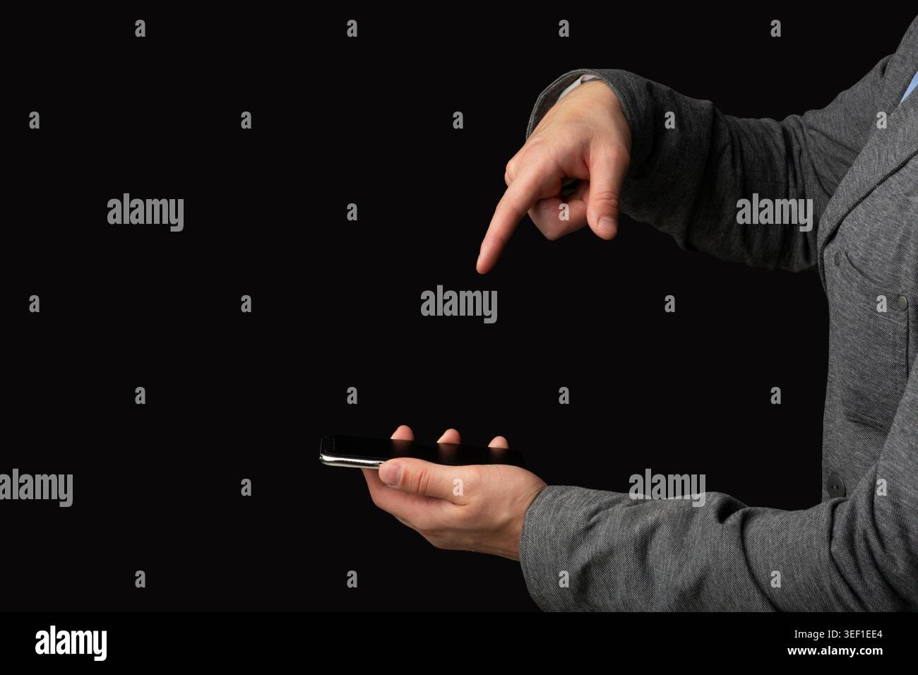 Person Interacting With Smartphone While Pointing at Screen in Dim Lighting Setting Stock Photo