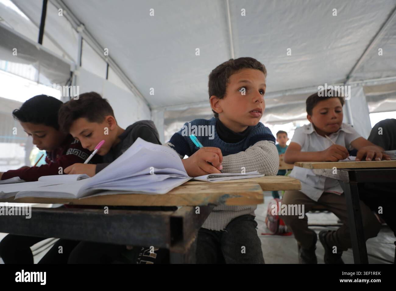 Students continue classes inside damaged school in central Gaza ...