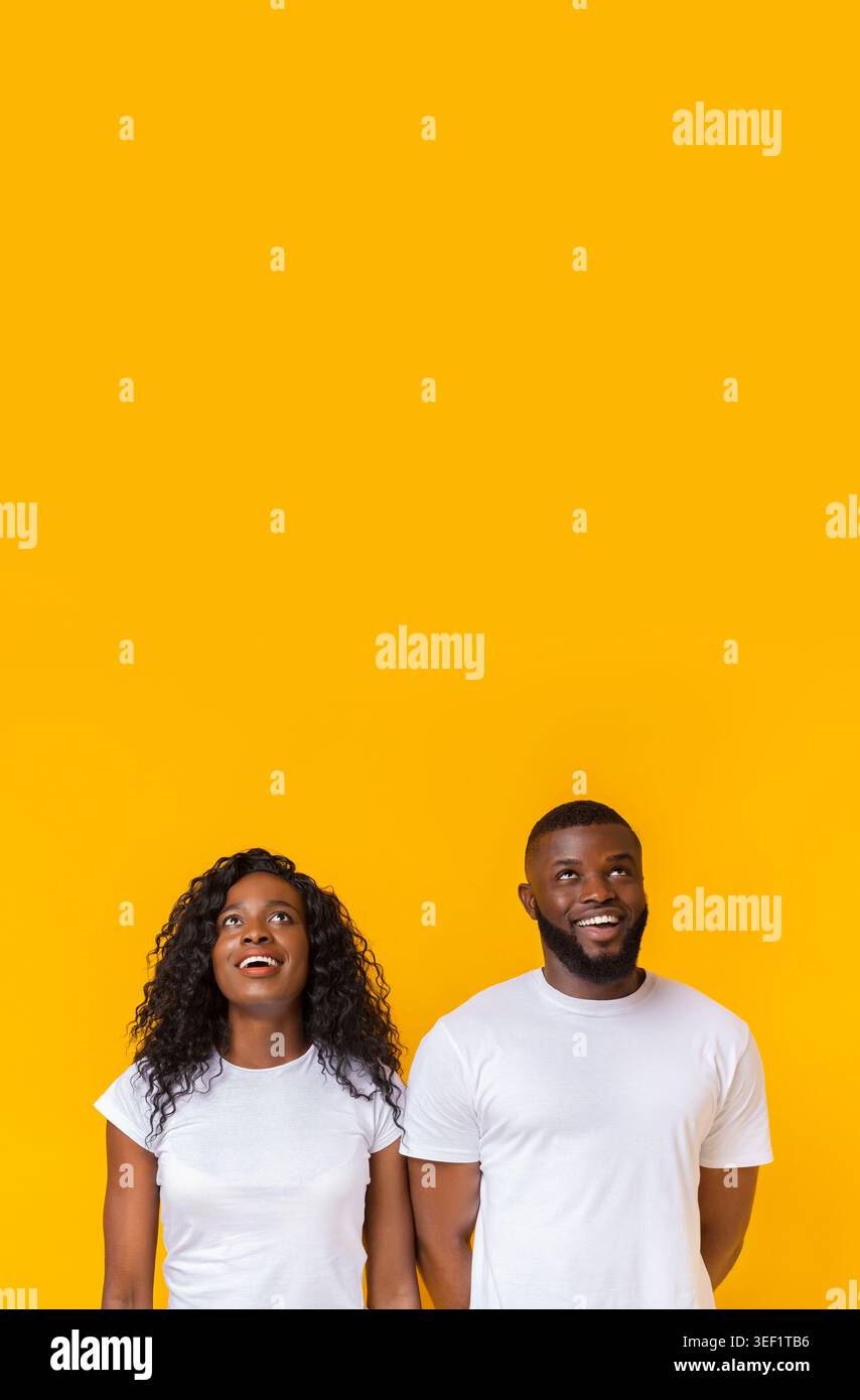Amazed african american man and woman looking upwards Stock Photo