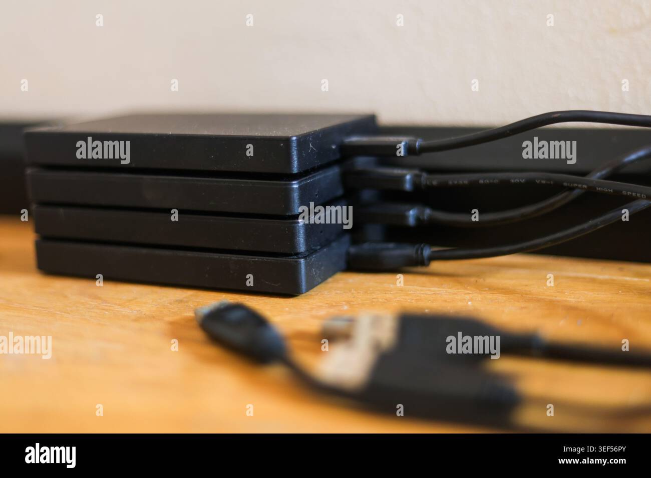 Stack of portable external hard drives representing digital storage backup and data security technology Stock Photo