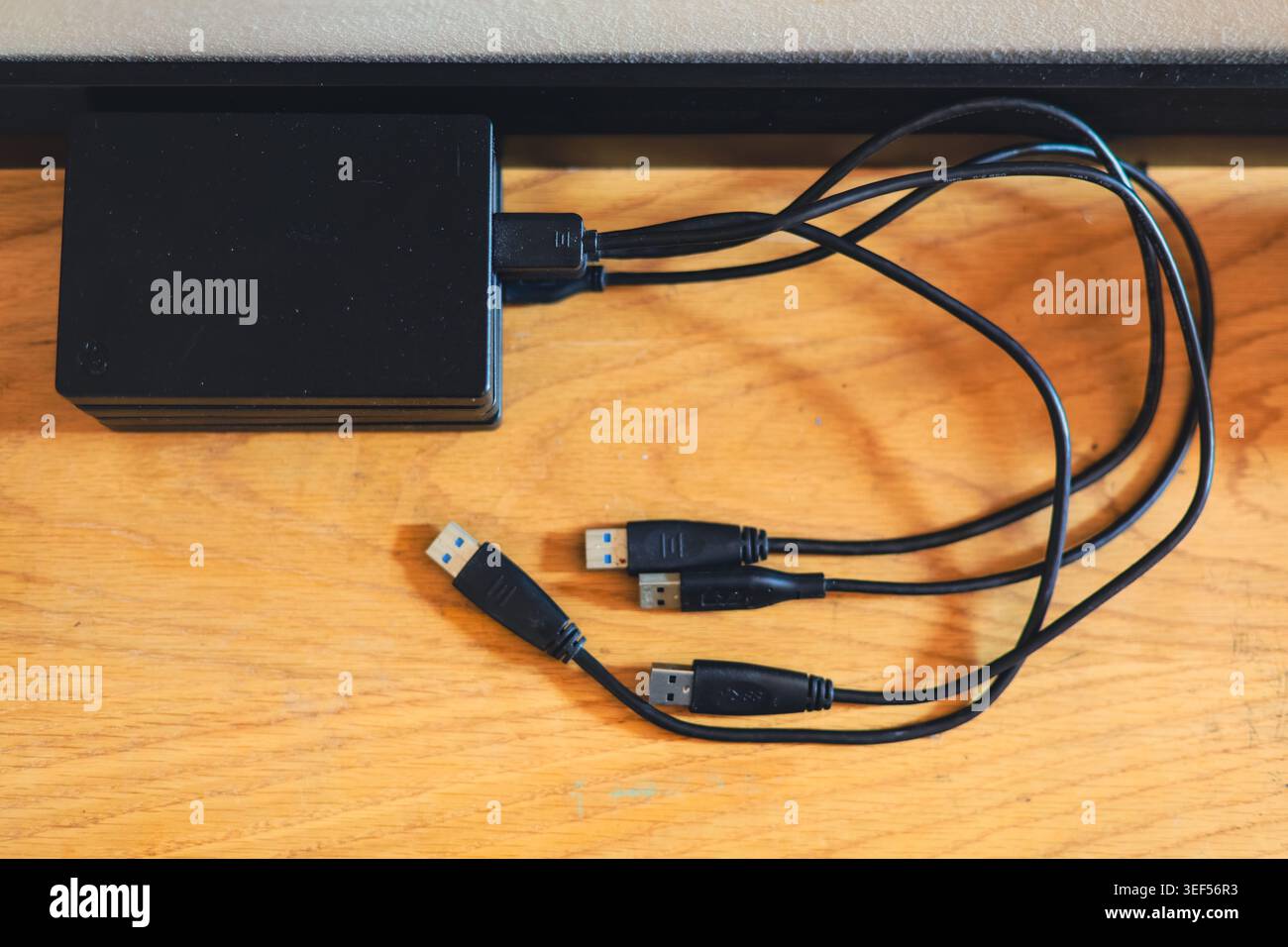 Stack of portable external hard drives representing digital storage backup and data security technology Stock Photo
