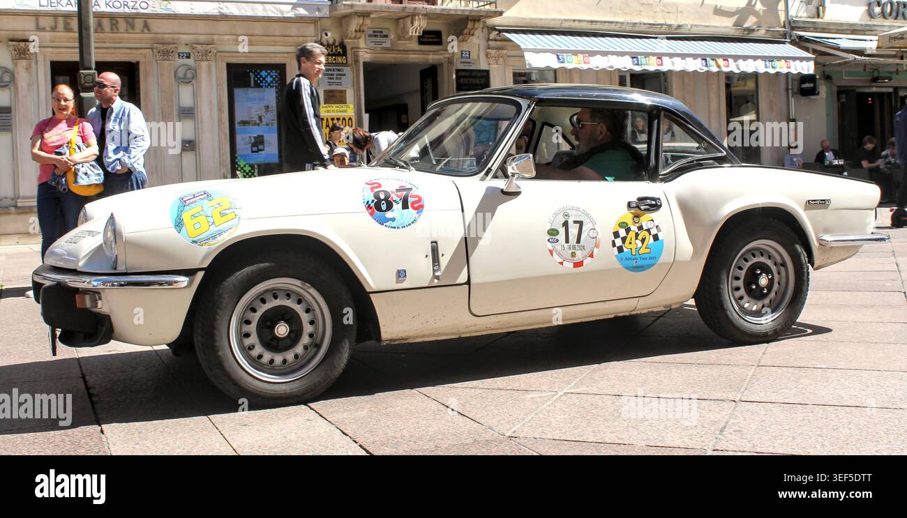 Triumph Spitfire Rally Classic white Triumph Spitfire MK IV with a black hardtop participating ...