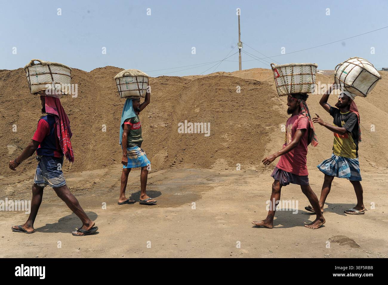 Worker carrie baskets with salt on their heads at the local raw salt ...