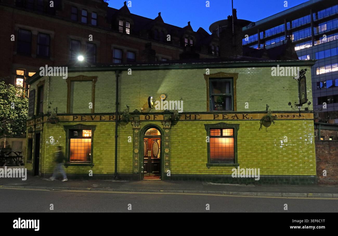 Dusk exterior of Peveril of the Peak, Manchester, a Grade II listed real ale pub with green tiled frontage Stock Photo