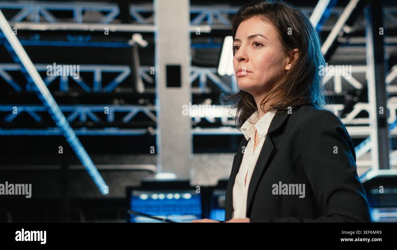 Technician walking in data center, using AR simulation to conduct security audit on IT infrastructure. Server room expert using VFX compositing visualization to verify firewall protection Stock Photo