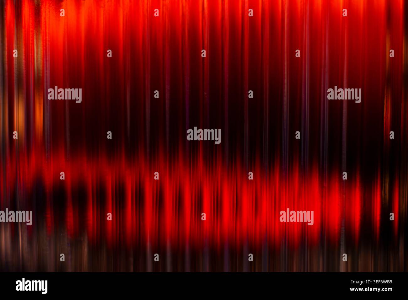 Abstract vertical deep red glowing light streaks on black background Stock Photo