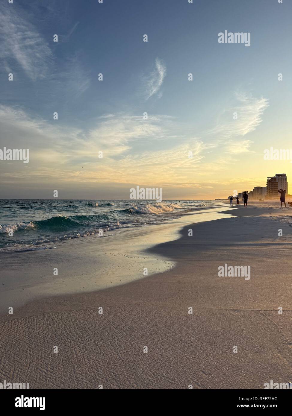 Destin Florida sunset with silhouette people walking along Gulf of Mexico water - Smartphone Captured Stock Image