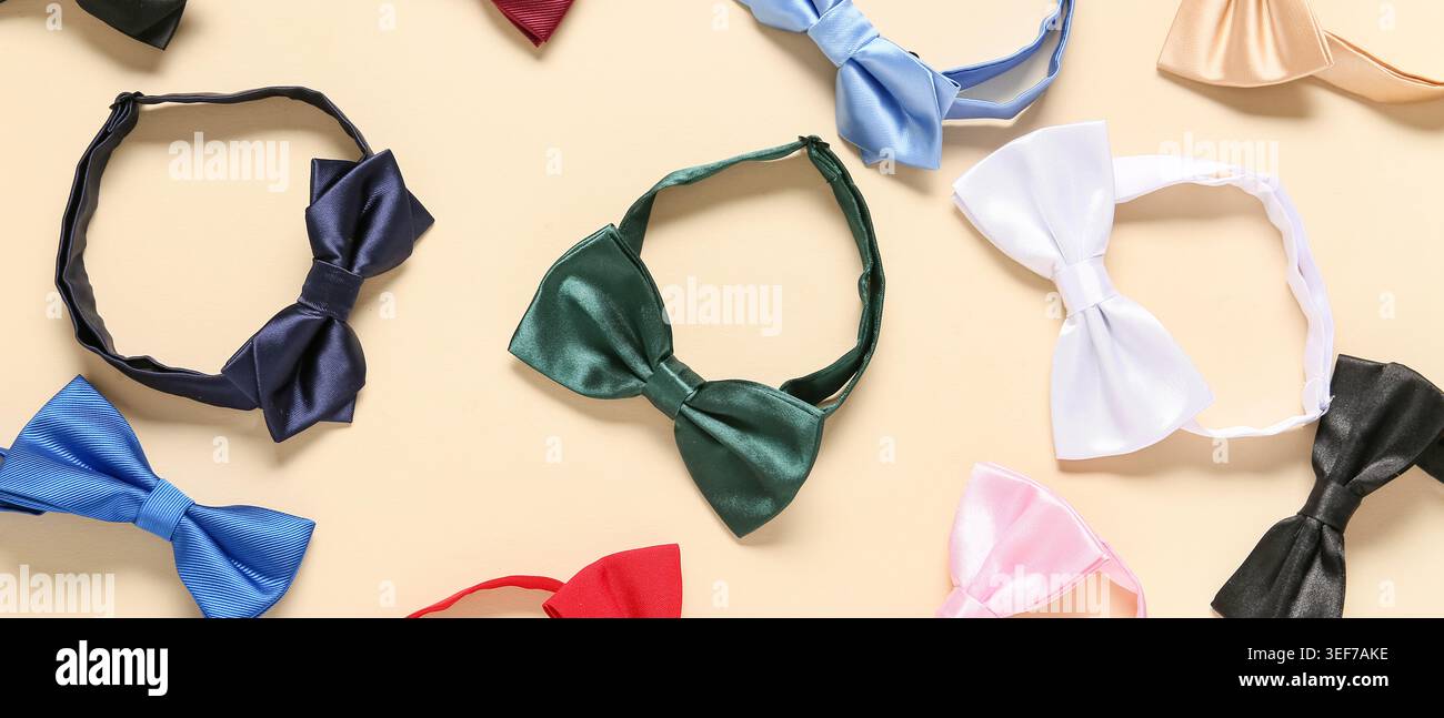 Different stylish bow ties on beige background Stock Photo