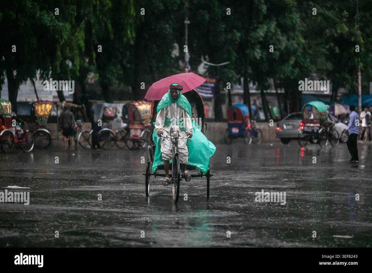 Dhaka, Bangladesh. 13th May, 2026. A rickshaw puller seen riding along the street on a rainy day. The heavy monsoon downpour made travel slow and dangerous. Credit: SOPA Images Limited/Alamy Live News Stock Photo