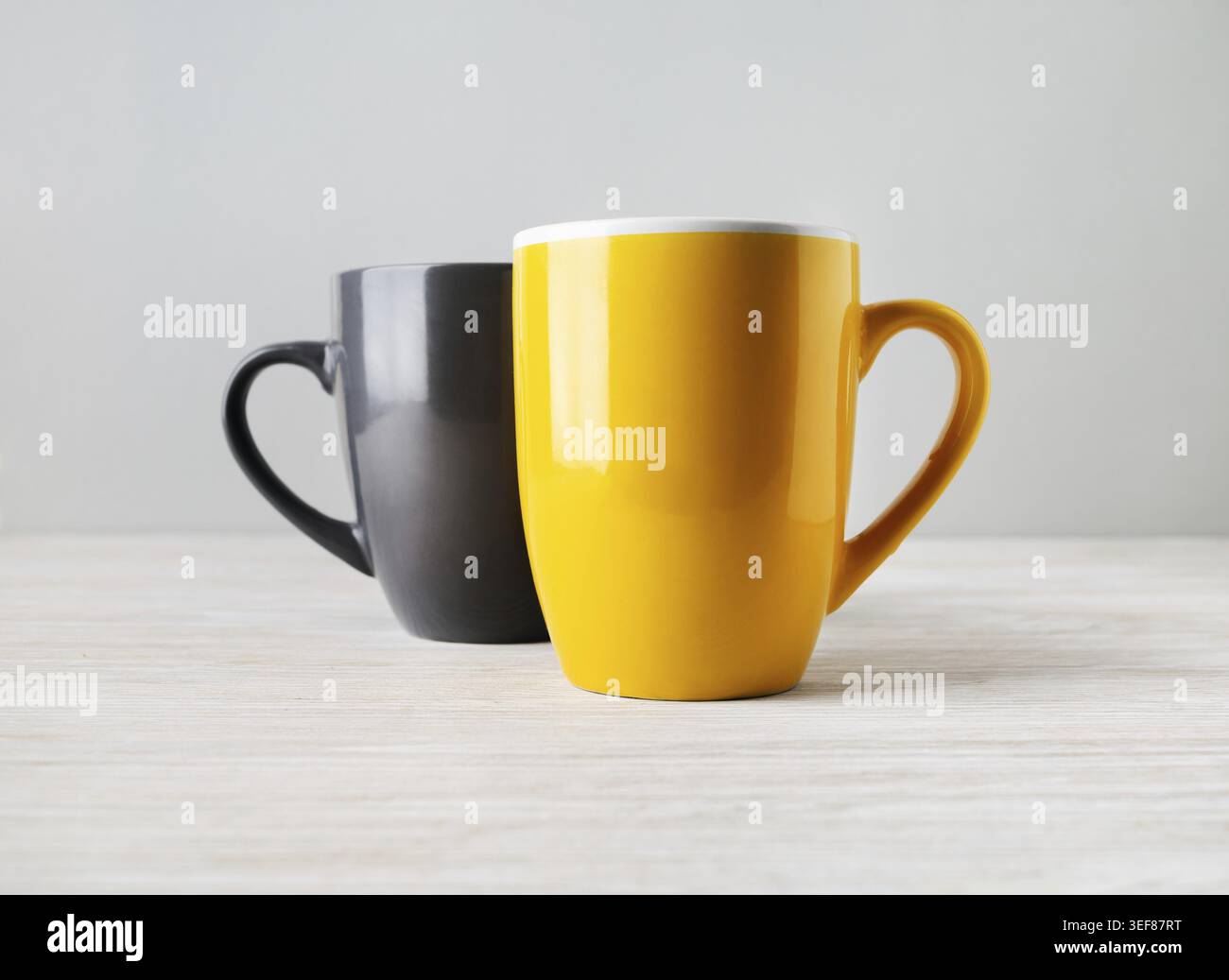 Two blank tea cups or coffee mugs. Responsive design mockup. Selective focus Stock Photo