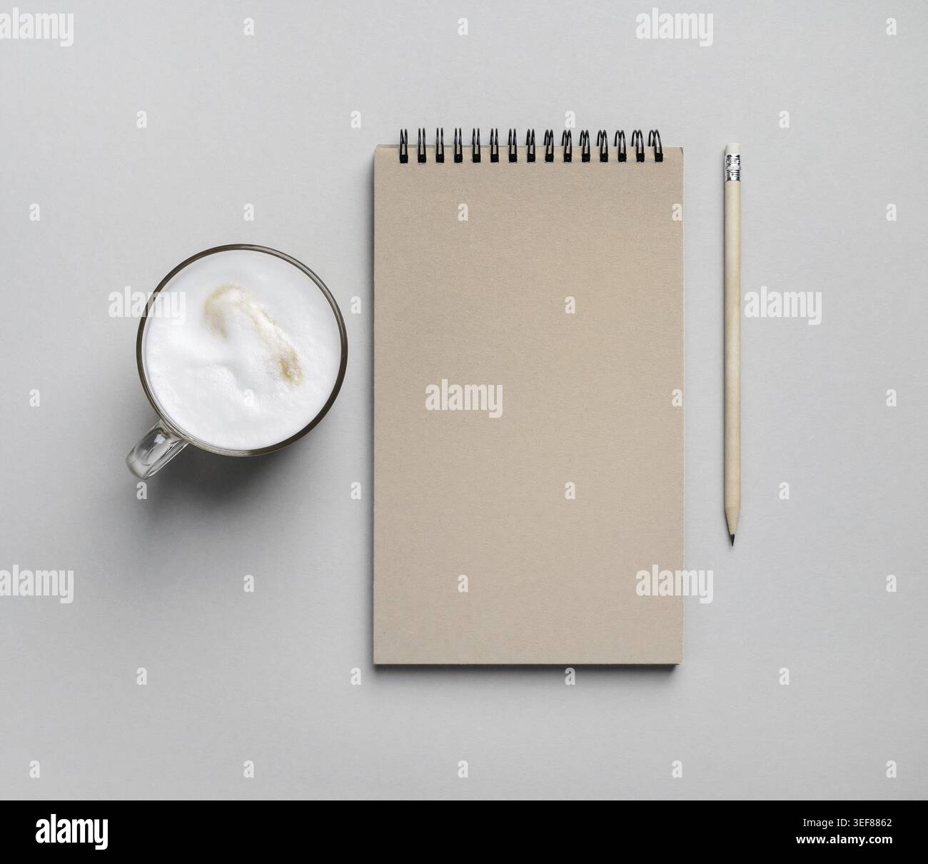 Blank notepad, coffee cup and pencil on paper surface. Flat lay Stock Photo