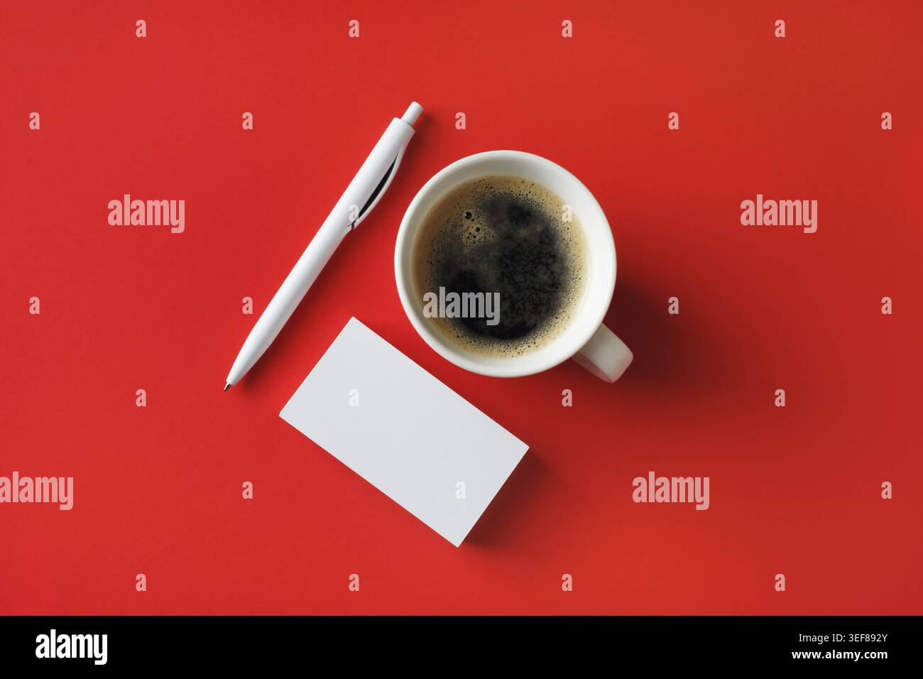 Branding ID template. Blank business cards, coffee cup and pen on red paper background. Flat lay Stock Photo