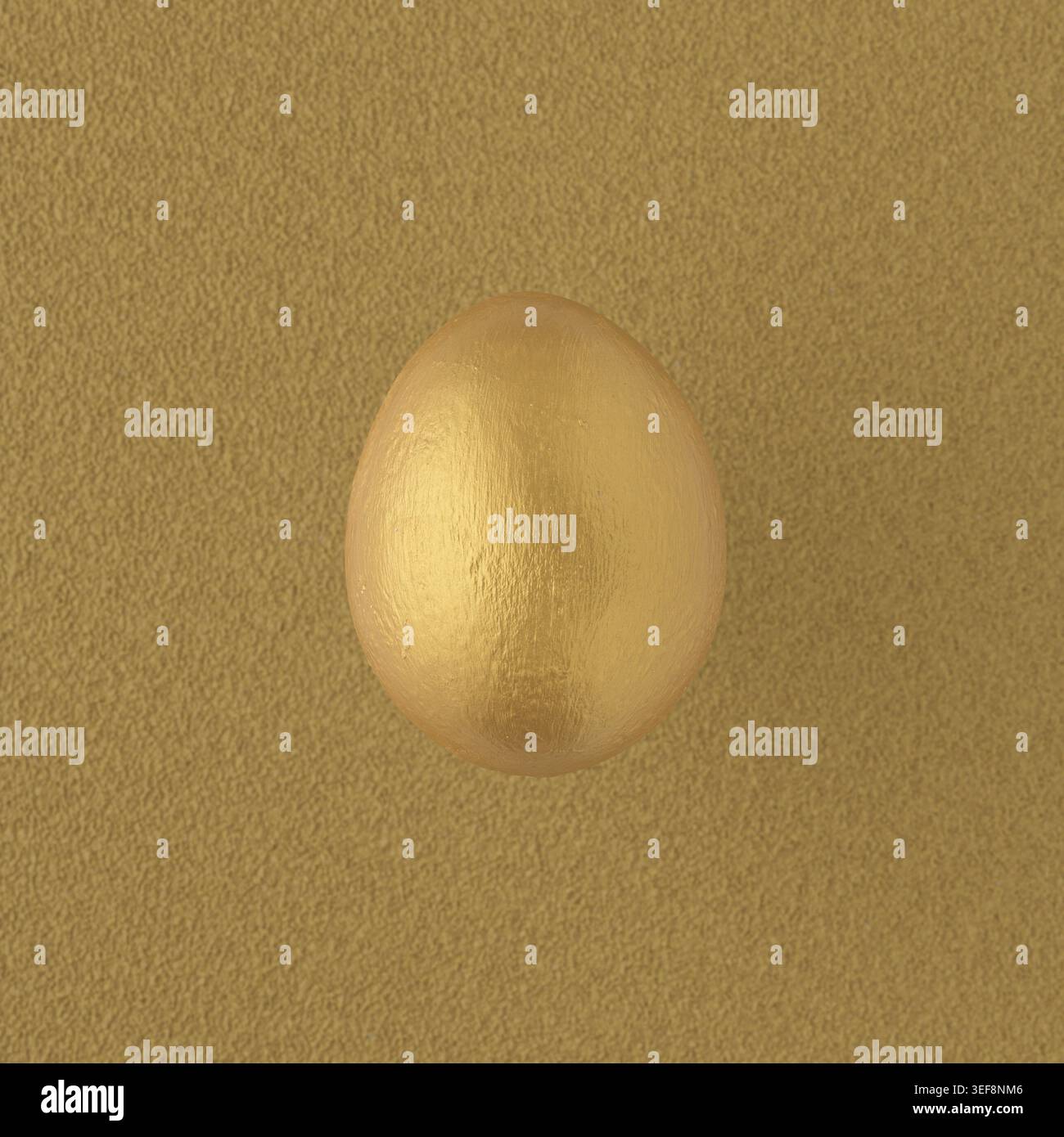 Golden painted egg on yellow background Stock Photo