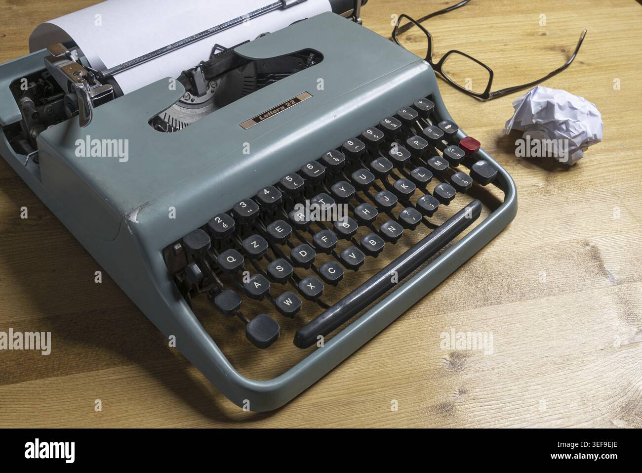 An old typewriter on a wooden table Stock Photo