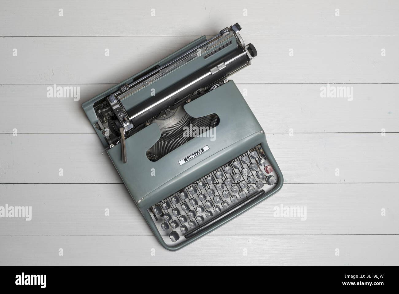 An old typewriter on a wooden table Stock Photo