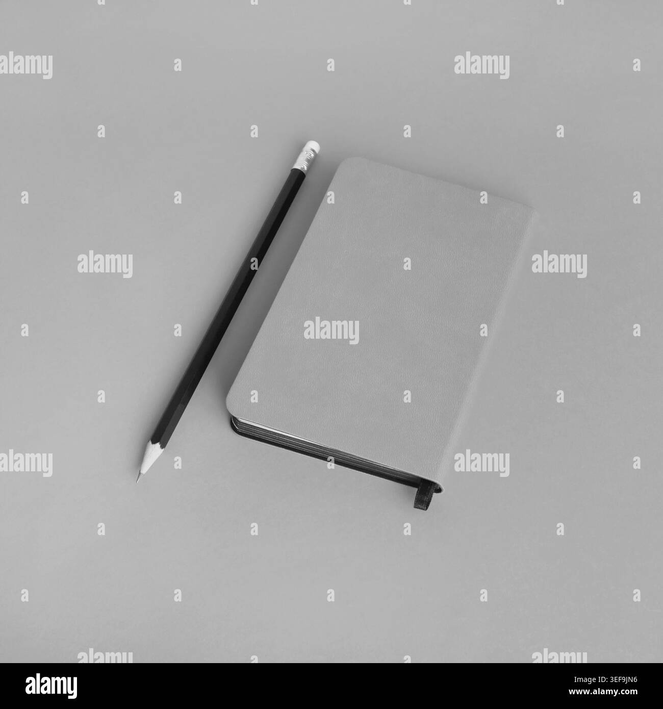 Blank notepad and pencil on gray paper background. Template for branding design Stock Photo
