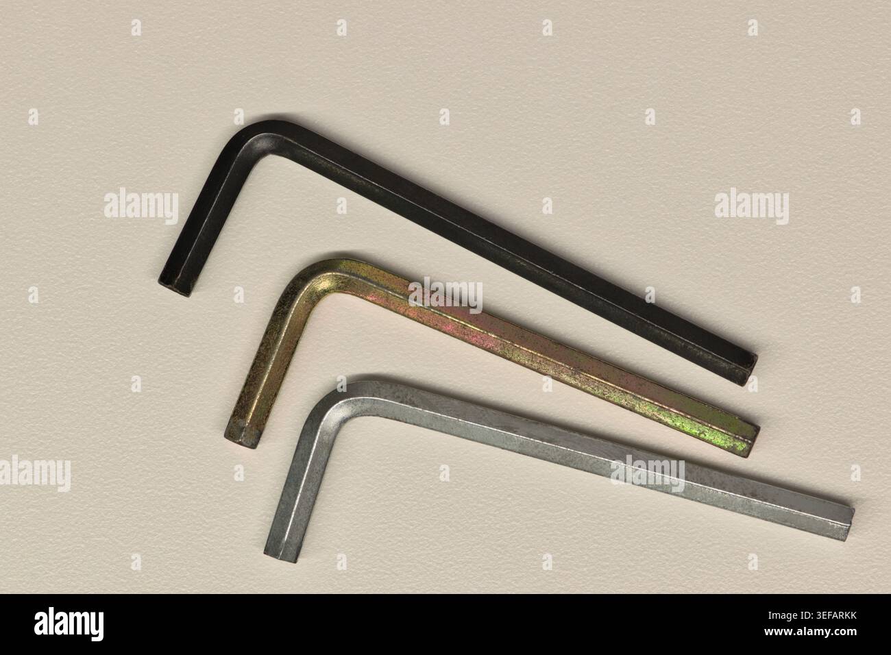 Three assorted allen wrenches flat lay on white background fastening tools. Stock Photo