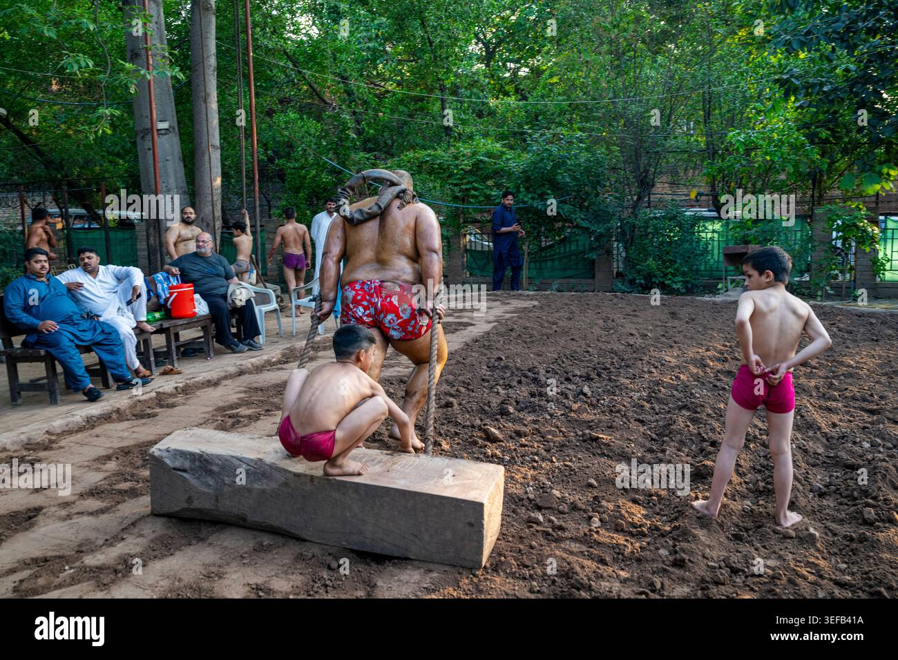 Mud wrestling event showcases local talent engaging in traditional sport in Lahore, Pakistan Stock Photo