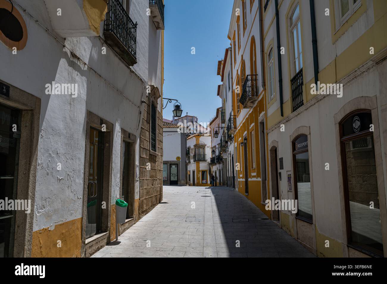 Exploring the narrow streets of the ancient city Evora in Portugal under the bright sun Stock Photo