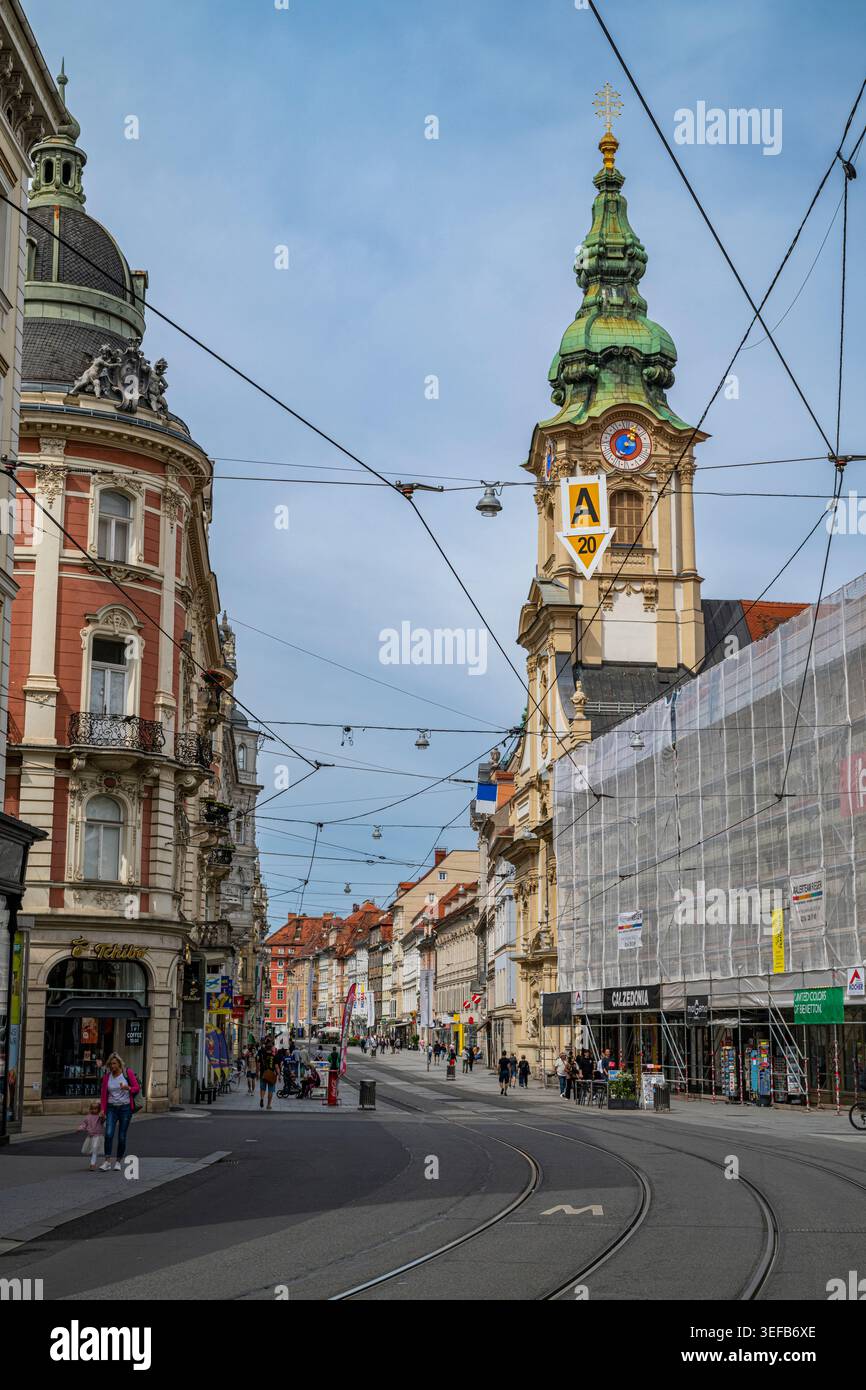 Exploring the streets of Graz with historic buildings and trolley lines Stock Photo