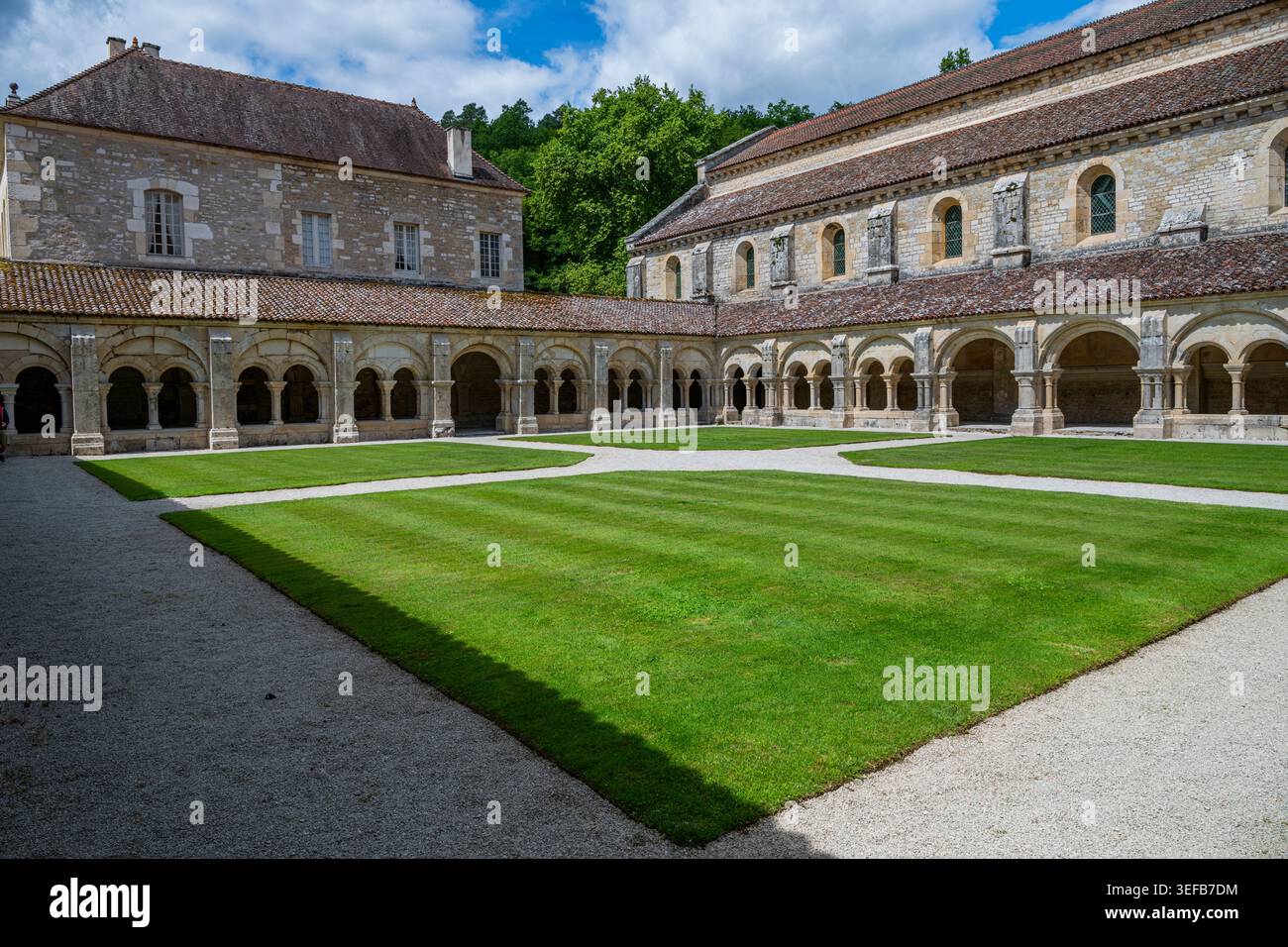 Historic Abbey of Fontenay showcases architectural simplicity and natural beauty in France's countryside during daytime Stock Photo