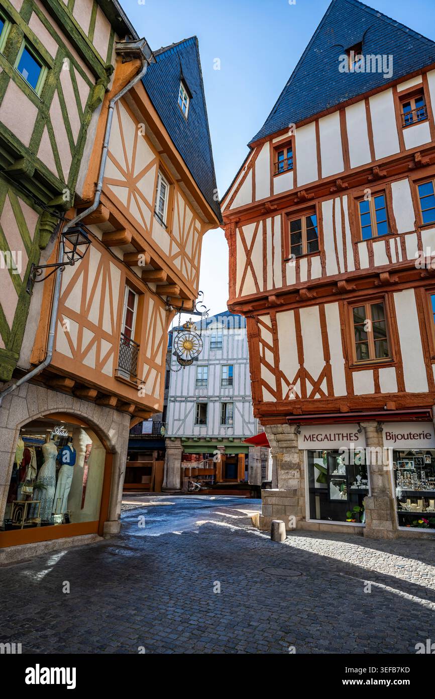Narrow street between wooden houses with shops in France at daytime Stock Photo