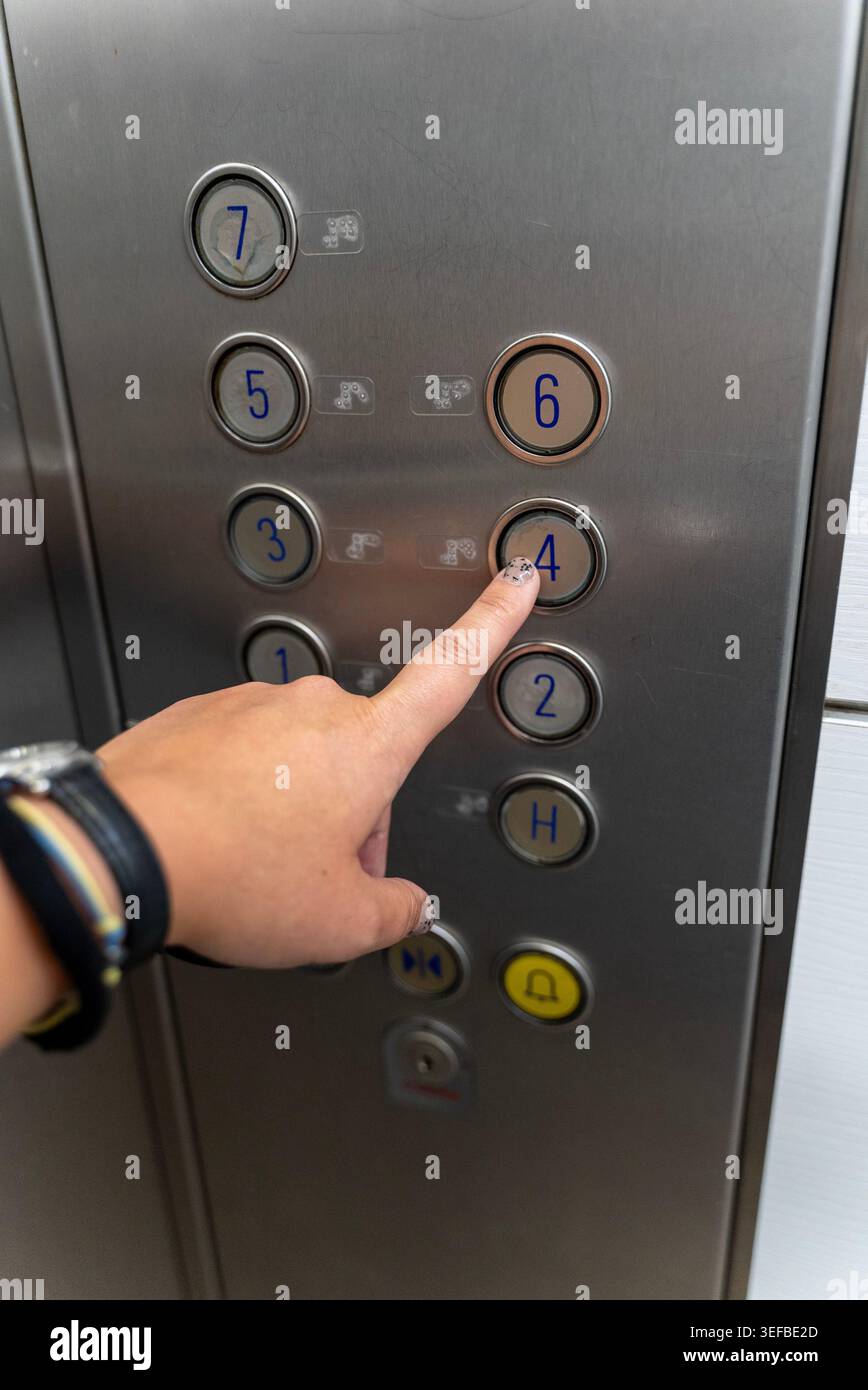 Person pressing elevator button inside modern lift cabin Stock Photo