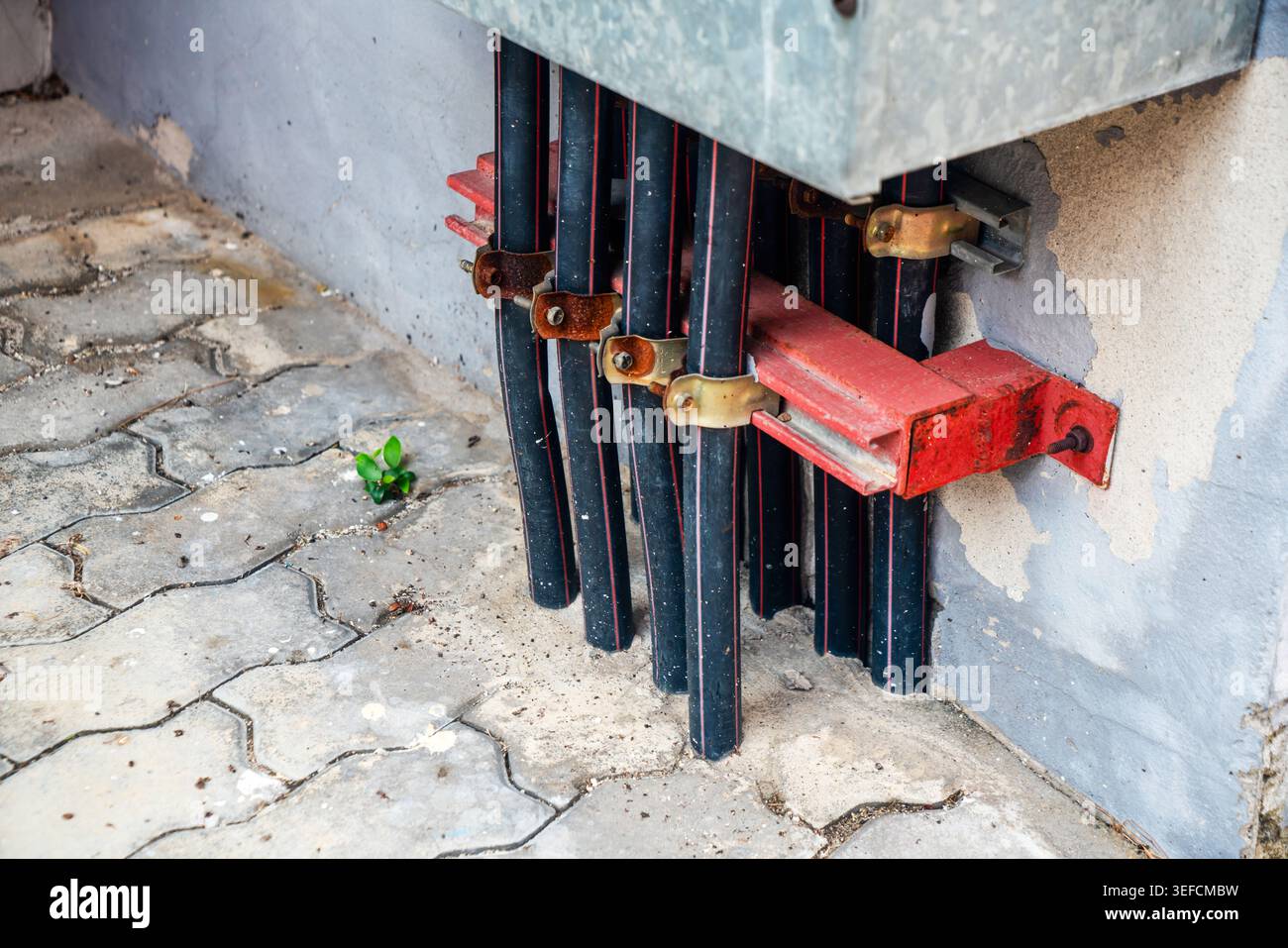 Close-up of electrical conduit pipes and wiring setup on a construction ...