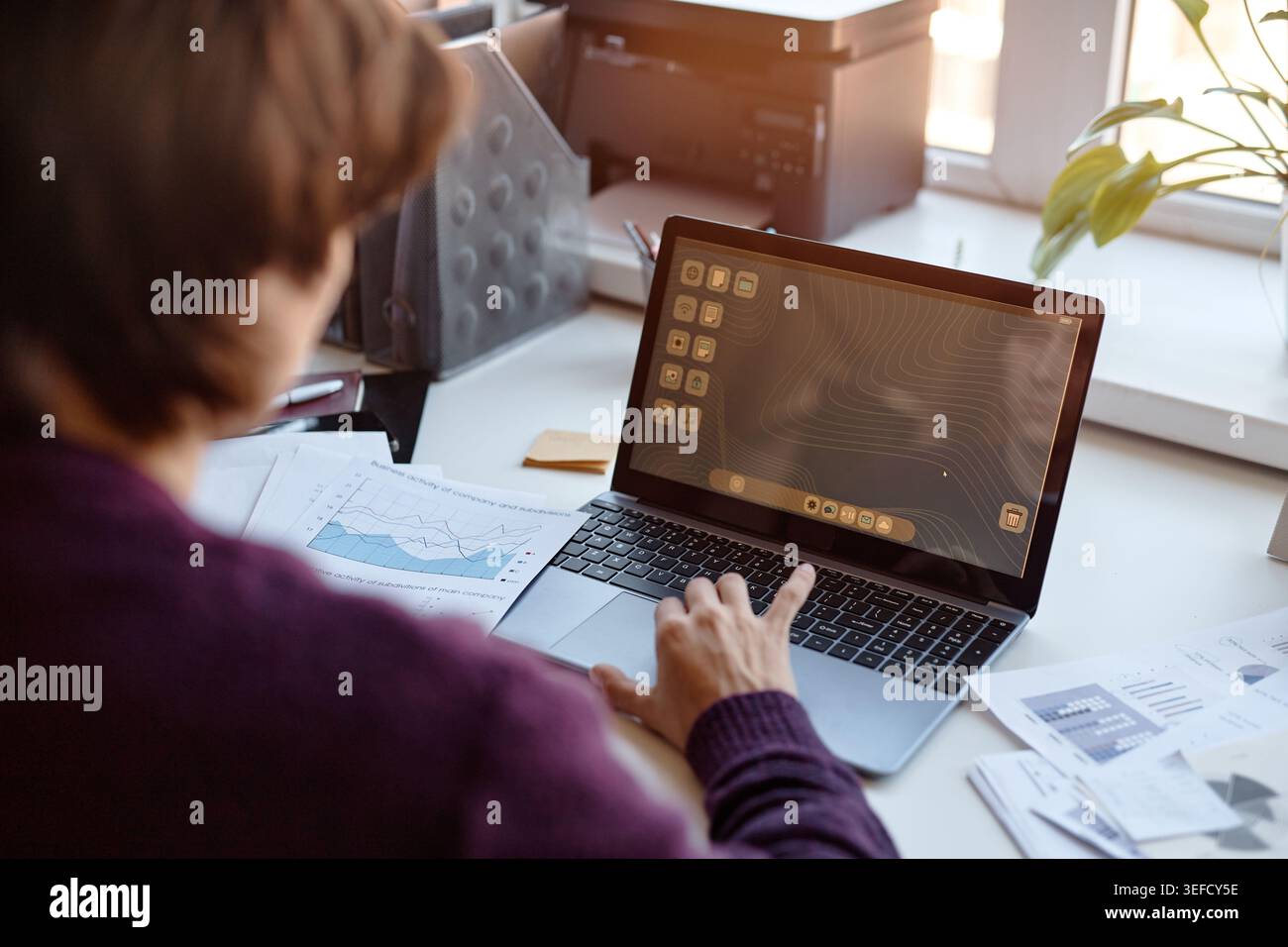 Middle Aged Woman Using Laptop for Business Data Analysis Stock Photo