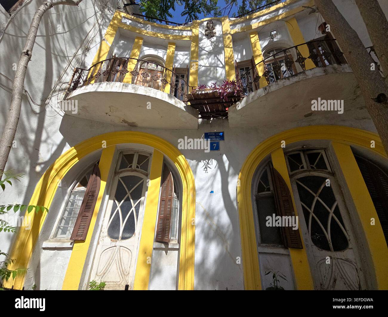 A beautiful eclectic building designed with Art Nouveau details, shutters, and balconies at the end of Plonit alley in Tel Aviv, Israel. Stock Photo