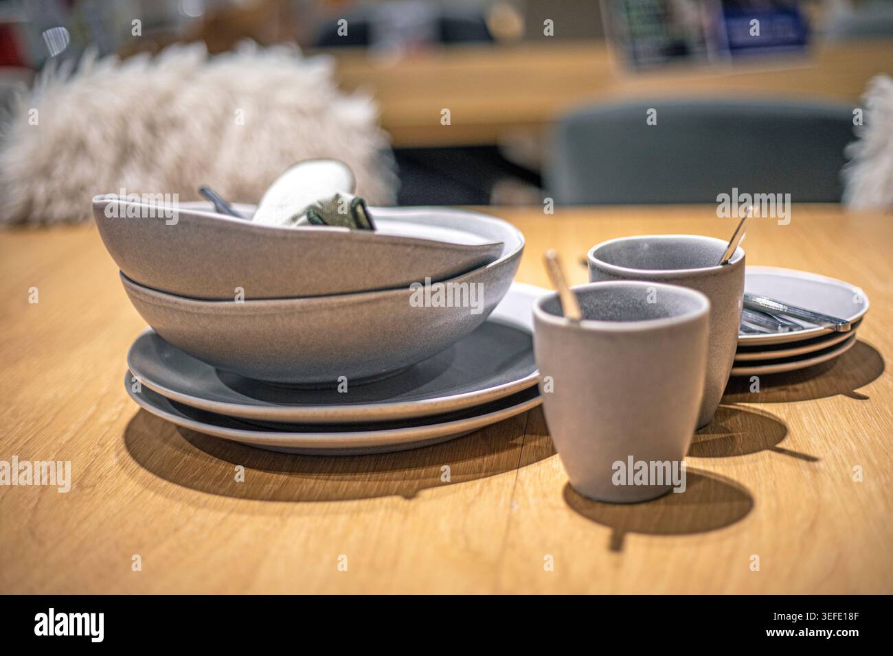 A stylish gray ceramic dinnerware set on the counter Stock Photo