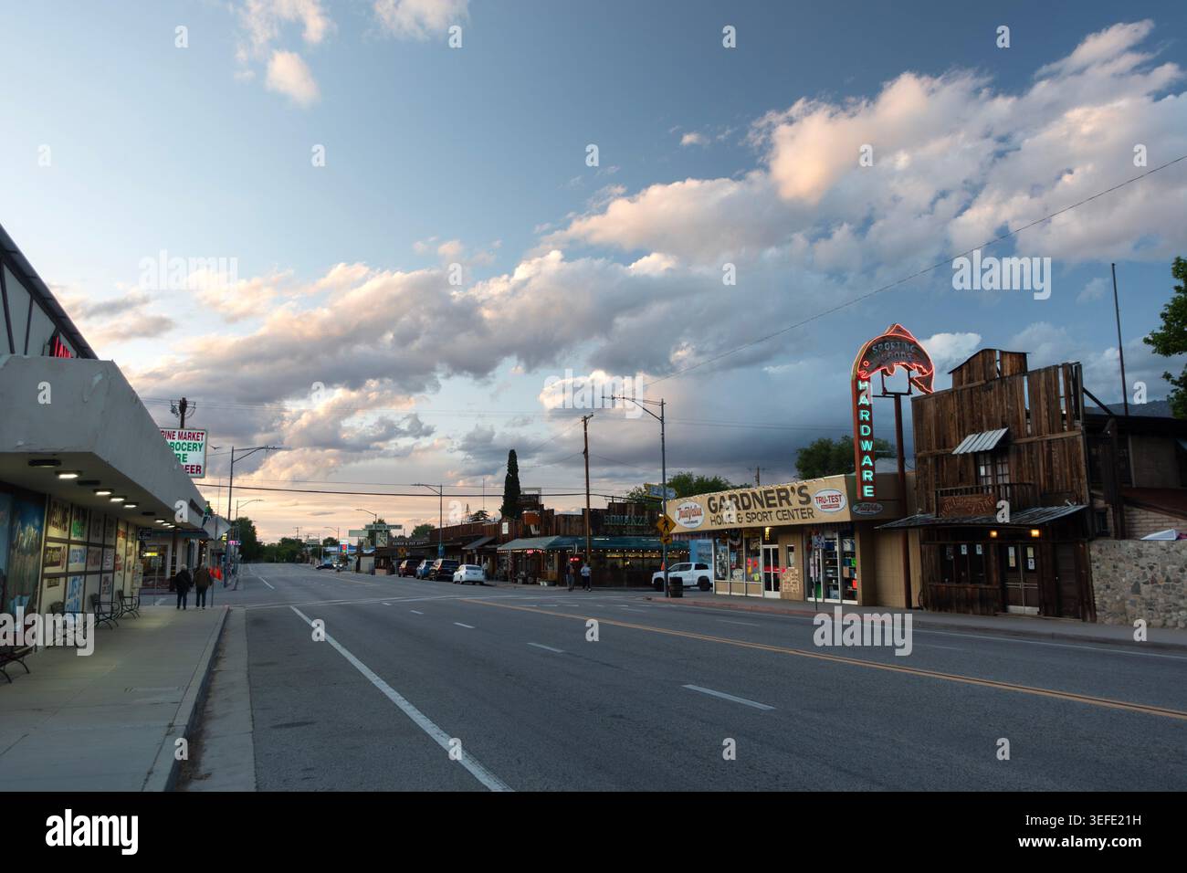 Moody dusk view of Highway 395 passing through the town of Lone Pine, California Stock Photo