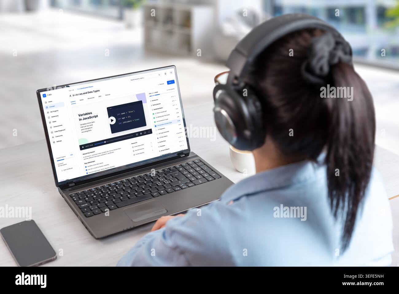 Coding course platform displayed on laptop during online study session, featuring programming lessons, developer dashboard and digital education inter Stock Photo