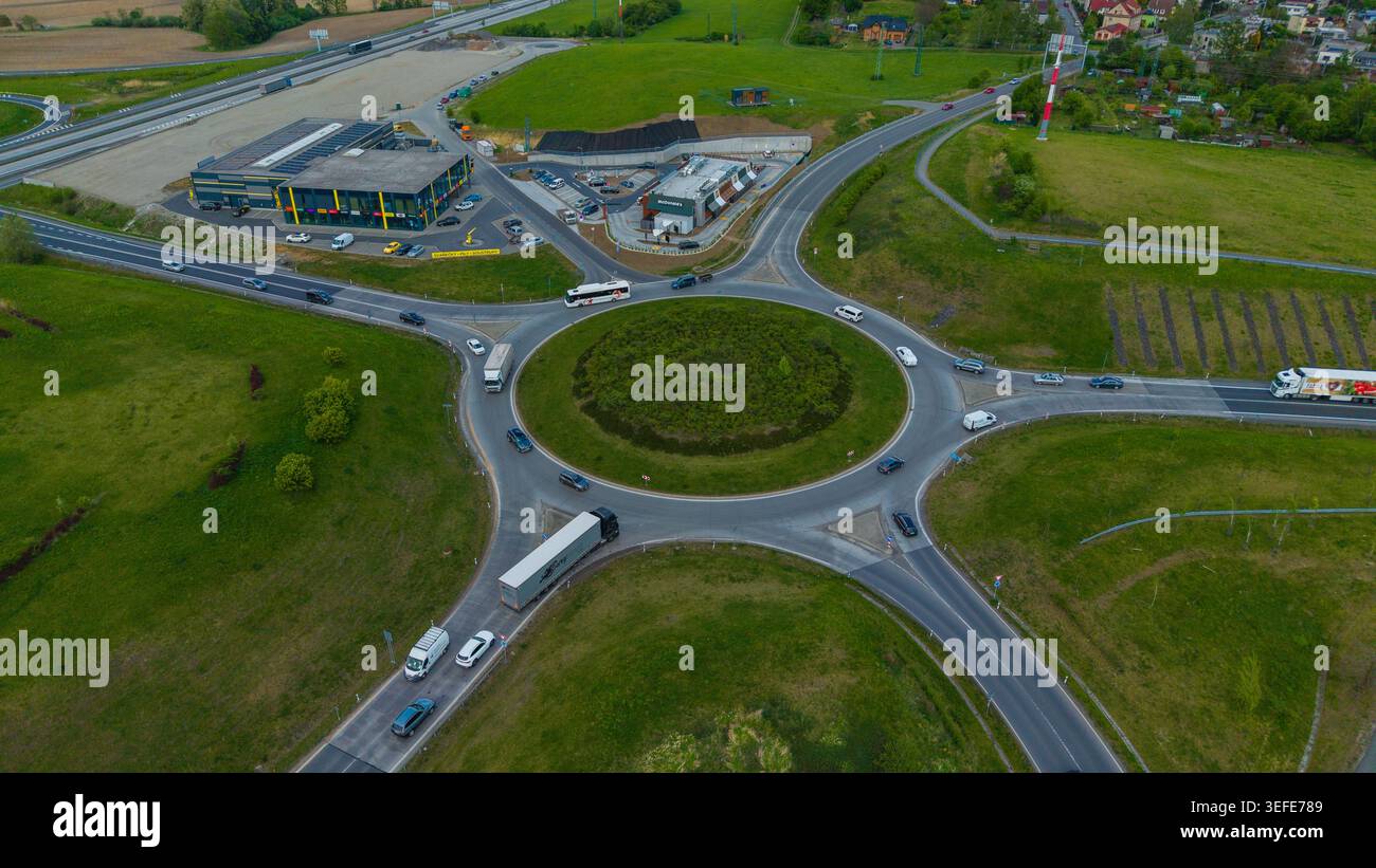 Aerial view of a busy traffic roundabout with cars and trucks moving ...