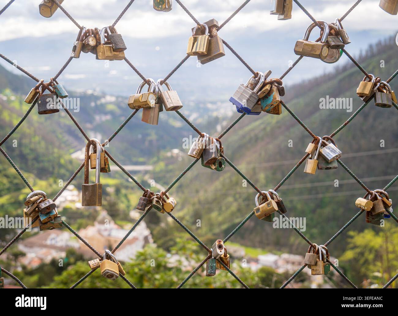 Love locks hanging on wire fence symbolizing eternal commitment Stock Photo