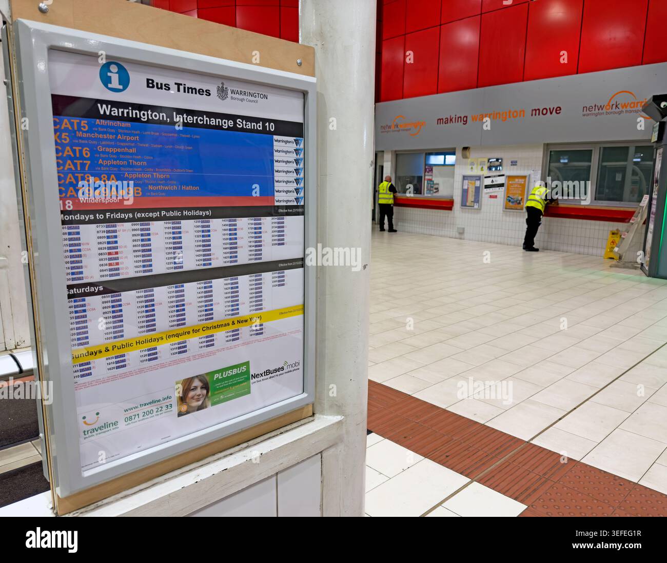 Warrington Interchange late at night, showing bus times for Stand 10 and an almost empty public transport concourse. Stock Photo