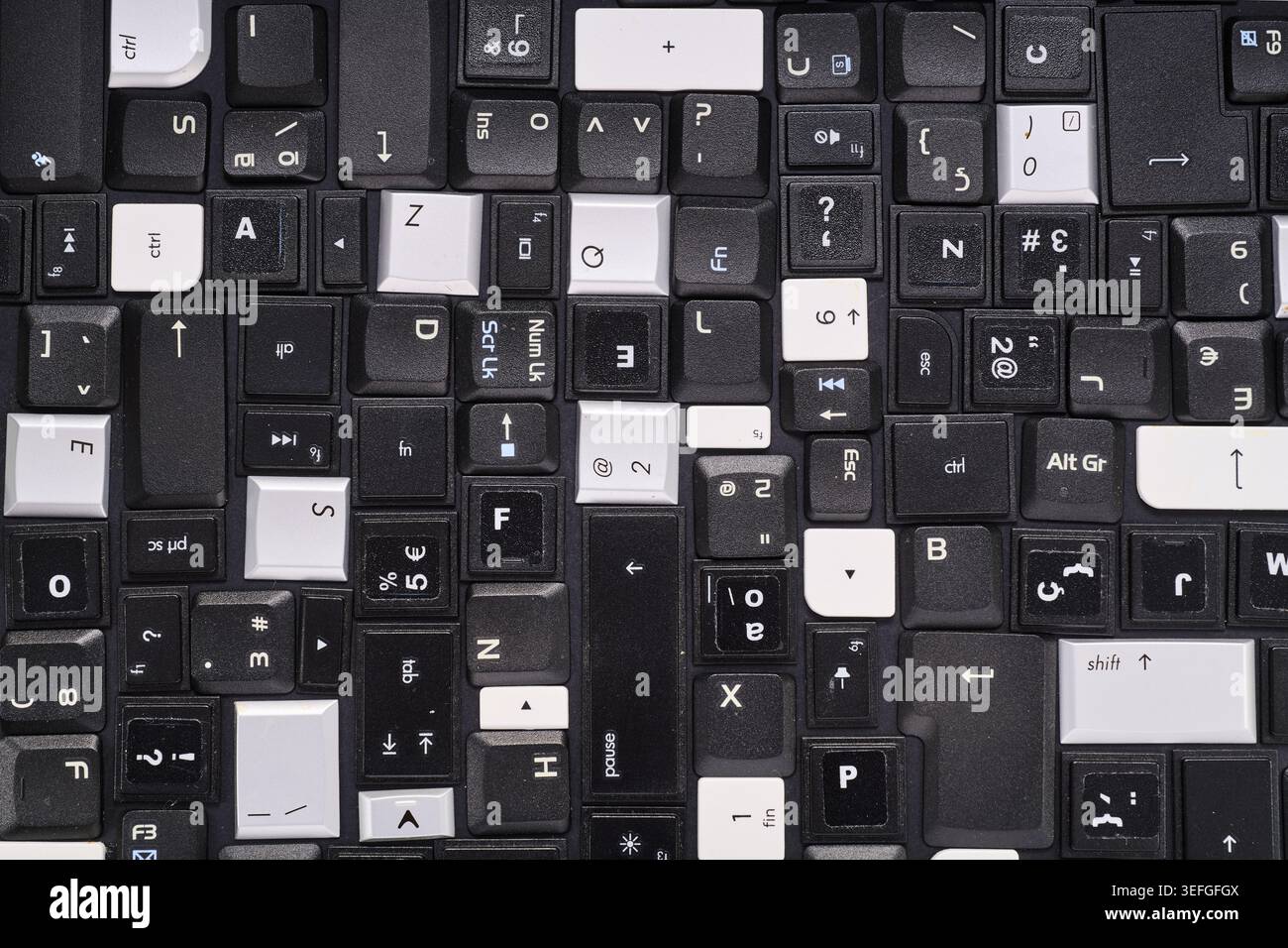 Close-up of a collection of keyboard keys from different old laptops on a table Stock Photo
